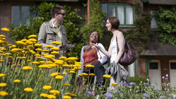 Visitors in the garden in summer at Shaw's Corner, Hertfordshire